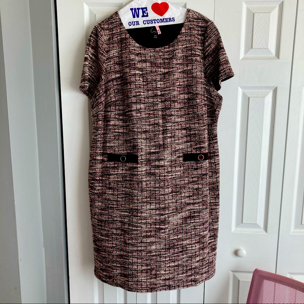 Sheath dress features a textural tweed fabric and decorative pockets.